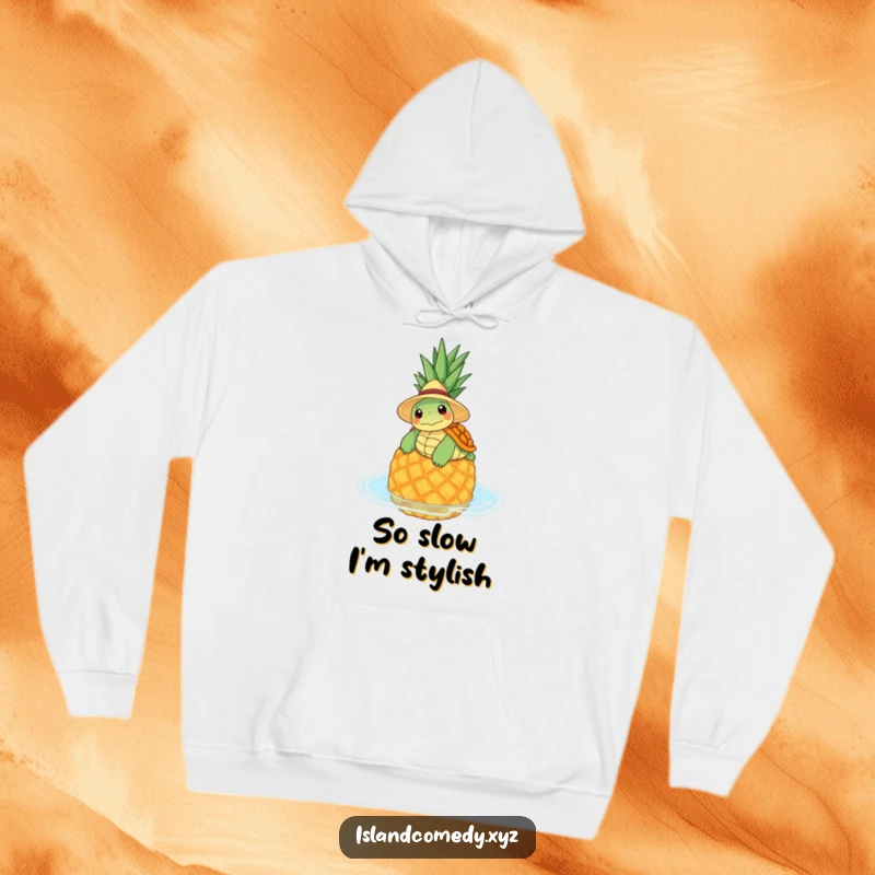 Funny hoodie depicting a relaxed turtle in a straw hat floating on a pineapple, offering cozy vibes.